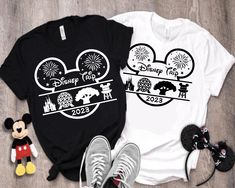 two tshirts with mickey mouse and fireworks on them, one is black and white