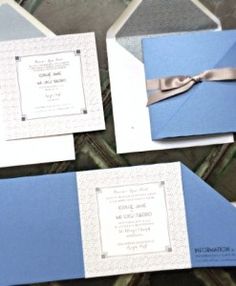 three blue and white wedding cards with silver ribbon