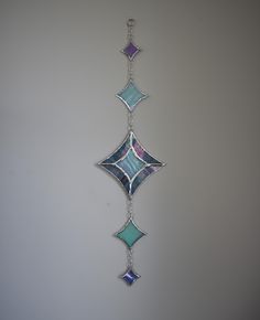 a multicolored glass piece hanging from a chain