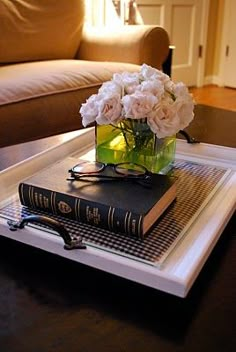 a table with flowers and books on it in the middle of an instagram page