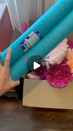 a person is holding an inflatable tube with flowers on it and the words how to make a flower bouquet out of balloons