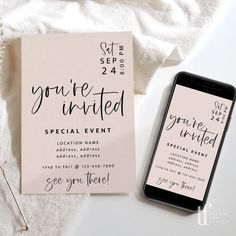 a phone sitting on top of a white table next to a pink and black wedding card