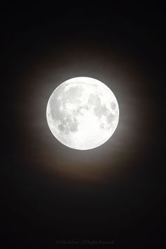 the full moon is shining brightly in the dark sky