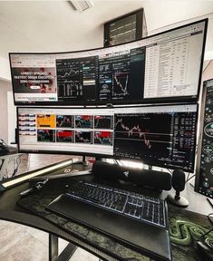 two computer monitors sitting on top of a desk next to each other with multiple screens