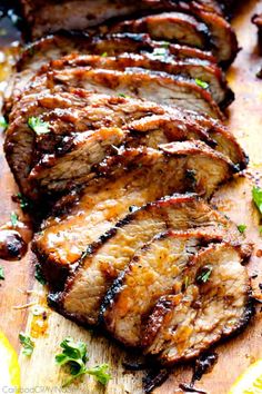 sliced meat on a cutting board with parsley