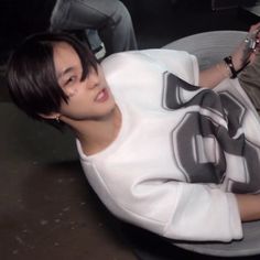 a young man laying on top of a white plate