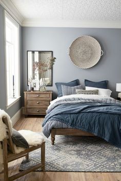 a bedroom with blue walls and wooden floors