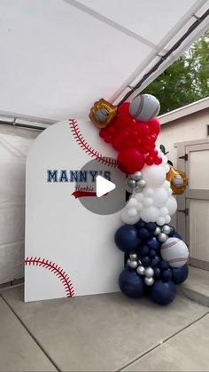 balloons and baseballs are on display under a tent