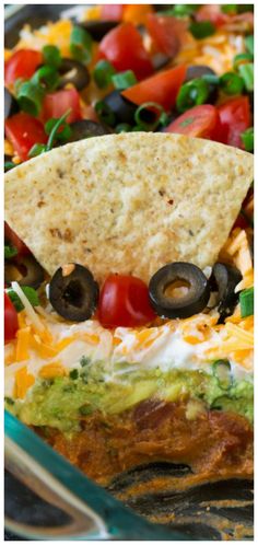 a tortilla sandwich with black olives, tomatoes and cheese