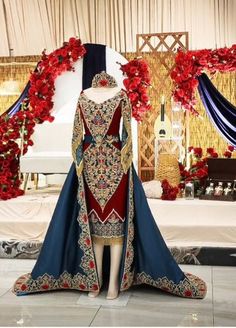 a dress on display in front of a decorated stage