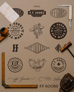 various logos and stickers on a piece of paper next to a pair of scissors