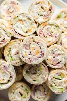 a white plate topped with rolls filled with different types of food