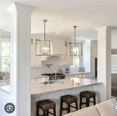 a kitchen with an island and bar stools