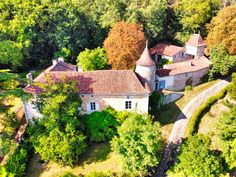 an aerial view of a house surrounded by trees