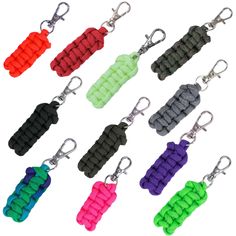 several colors of key chains are shown on a white background with clippings attached to them