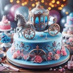 there is a blue cake with a horse drawn carriage on the top and pink roses around it