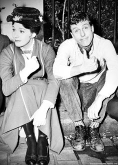 an old photo of two people sitting on the steps