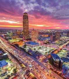 an aerial view of a city at sunset