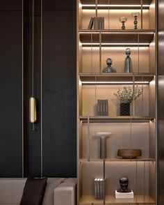 a living room filled with lots of furniture next to a tall book shelf covered in books