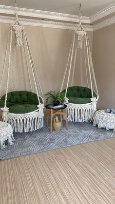 a living room with hammock chairs and rugs on the floor