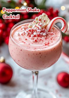 peppermint shake cocktail with candy cane garnish in a glass on a table