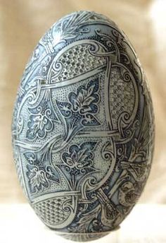 an ornately decorated egg sitting on top of a table