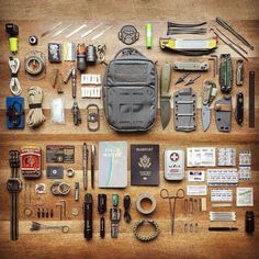 an assortment of items are laid out on a table together to be used as a survival kit