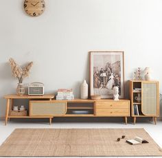 a living room with a rug, bookshelf and clock on the wall above it