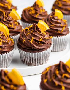 cupcakes with chocolate frosting and orange zest sprinkles on top