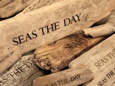 several pieces of wood that have been cut into smaller pieces with the words seas the day written on them