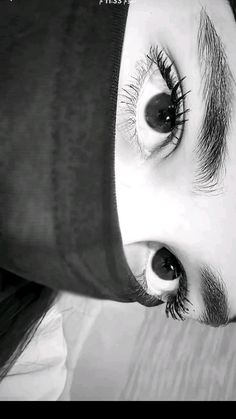 a close up of a person's face with long eyelashes and eyeliners