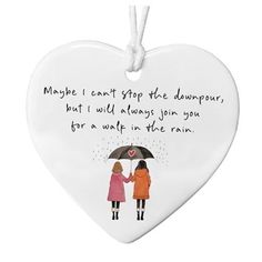 a heart shaped ornament with two girls holding an umbrella and saying maybe i can't stop the dampons, but i will always join you for a wet in the rain