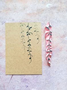 a piece of paper with some plants on it next to a pencil and eraser