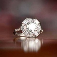 a diamond ring sitting on top of a wooden table