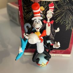 the cat in the hat figurine is next to a christmas ornament