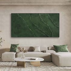 a living room with a large green painting on the wall and white furniture in front of it