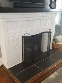 a white brick fireplace with a television above it