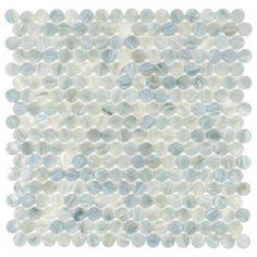 a white and blue glass mosaic tile with small dots on the bottom half of it