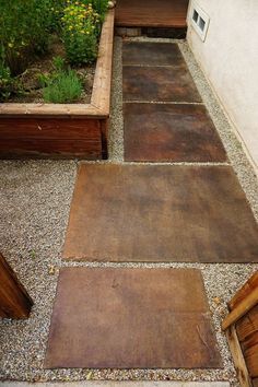 an outdoor area with wooden benches and gravel