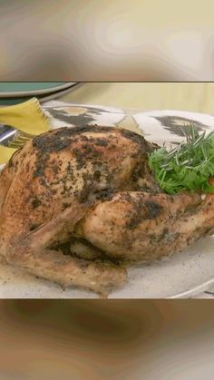 a whole chicken sitting on top of a white plate