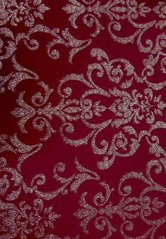 a red and white wallpaper with silver swirls on it's surface,