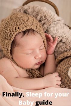 a baby sleeping with a teddy bear on top of it's head and wearing a knitted hat