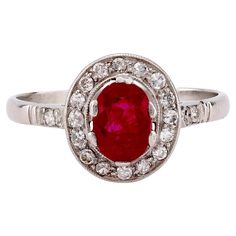 Center Stone: Oval Cut Ruby Weight: 1.03 Carat Accent Stone: 20 Single Cut Diamonds Weight: Approximately .30 Carats Color: H Clarity: SI Metal: Platinum Era: Modern in the Style of Art Deco Circa: 2020's Hallmarks: Stone Weight Engraved Size: 8 and can be resized Gram weight: 3.93 This stunning Art Deco-inspired cluster ring from the 2020s features a captivating 1.03-carat oval cut ruby at its center, radiating a rich, deep red hue. Encircling the ruby are 20 sparkling single cut diamonds, totaling approximately 0.30 carats, with H color and SI clarity, adding a brilliant contrast to the design. Crafted in platinum and engraved with the stone weight, this 3.93-gram ring combines modern craftsmanship with timeless Art Deco elegance, making it a sophisticated choice for any jewelry collecti Platinum Halo Ring, Vintage Cocktail Ring, Platinum Diamond Rings, Gold Cocktail Ring, 1920s Art, Art Deco Engagement, 1920s Art Deco, Deco Engagement Ring, Timeless Art