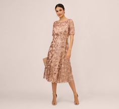 When the occasion calls for an elevated look, this sequin dress is at the ready. This midi dress features a fitted bodice with a sheer boat neckline, sheer short sleeves, and a flared skirt. Boasting a partial lining that gives the illusion of a scoop neck and an open back, this dress has a mesh overlay with floral embroidery that is inset with mini sequins. A zipper closure at the back completes this semi-formal dress. Styled with a nude heel and a beaded clutch, this floral cocktail dress is a Non Traditional Wedding Dresses, Floral Beaded Dress, Non Traditional Wedding, Unconventional Wedding Dress, Floral Cocktail Dress, Semi Formal Dress, Embroidered Midi Dress, Traditional Wedding Dresses, Sheer Shorts