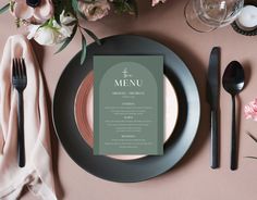 a table setting with place settings, napkins and silverware on top of it