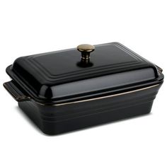 a black casserole dish with gold trim