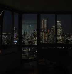 the city lights are lit up at night from this room's window sill