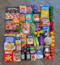 a pile of food sitting on top of a wooden floor next to vegetables and fruit