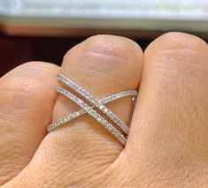 a woman's hand with a diamond ring on it