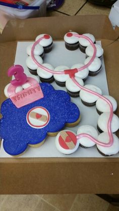 a birthday cake in the shape of a car with pink and blue frosting on it